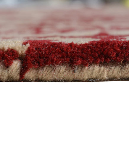 Traditional wool rug with intricate red damask-style motifs