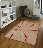 Beige rug with red and cream abstract leaf pattern on wooden floor in modern living room