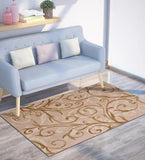 Beige and tan transitional rug with swirling vine pattern under light blue sofa with pillows in modern living room