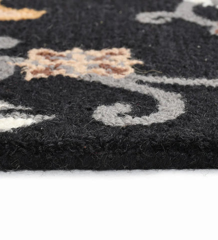 Hand-tufted black rug with traditional floral Oriental pattern