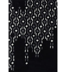 Abstract black hand-tufted wool rug with grey and white dot pattern