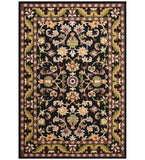 Black traditional hand-tufted wool rug with floral and vine motifs in green, beige, brown colors