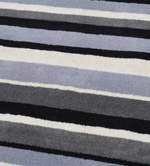 Hand-tufted wool area rug with modern monochrome stripe design.