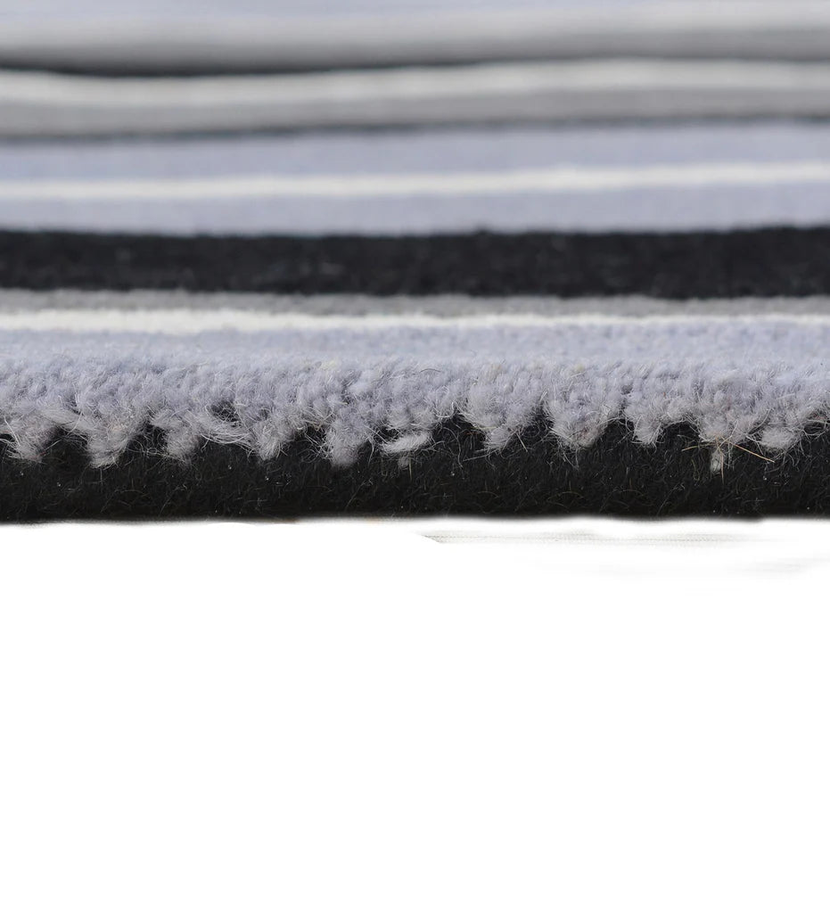 Contemporary striped wool rug in gray, white, and black tones.