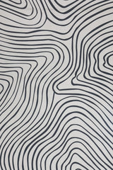 Contemporary monochrome rug with bold wave pattern.