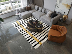 Luxury artisan rug with bold black stripes and vertical mustard line.
