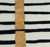 Modern striped rug with black, white, and golden accents in a geometric pattern