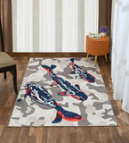 Handwoven luxury area rug featuring three blue and red koi fish on a gray and white abstract background, placed on wooden floor in a modern living room
