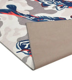 Close-up of a modern blue and gray abstract patterned handwoven rug with coral accents, showing textured beige backing