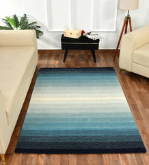 Modern artisan rug featuring teal, cream, and navy gradient