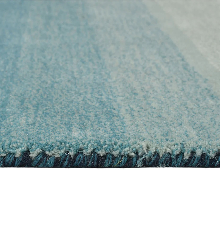 Gradient ombre wool rug in blue, cream, and teal shades