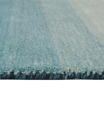 Gradient ombre wool rug in blue, cream, and teal shades