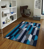 Modern living room with blue hand-tufted geometric wool rug on wooden floor next to brown lounge chair