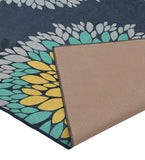 Blue floral rug with teal, yellow, and gray petals, showing woven backside detail