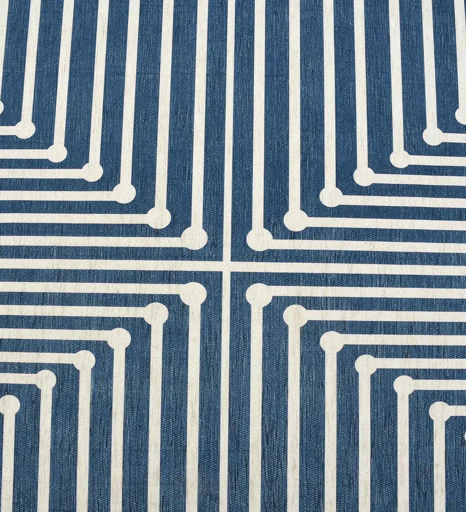 Low-profile blue rug with navy and white geometric accents.