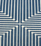 Close-up of a luxury handwoven blue rug with white geometric maze pattern from Mannat Rugs