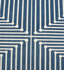 Low-profile blue rug with navy and white geometric accents.