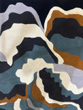 Abstract patterned modern handwoven luxury rug in blue, brown, black, cream, and gray colors