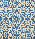 Blue Moroccan style rug with intricate white geometric floral patterns and textured background
