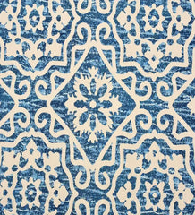 Blue Moroccan style rug with intricate white geometric and floral patterns