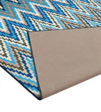 Blue pixelated chevron patterned luxury rug with beige non-slip backing from Mannat Rugs