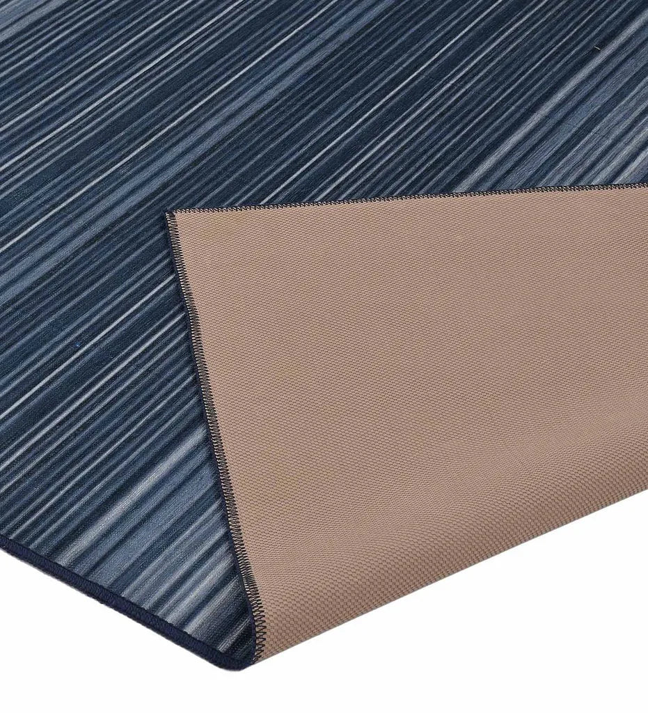 Washable rug with alternating blue stripe design.