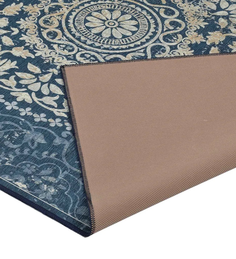 Distressed vintage blue area rug with central medallion design.