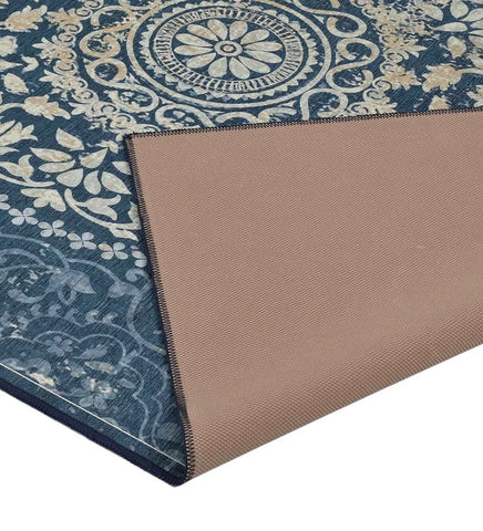 Distressed vintage blue area rug with central medallion design.