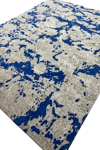 Abstract handwoven wool rug in blue and grey-beige tones.
