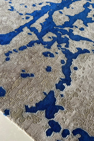 Blue and beige contemporary rug featuring abstract geometric effect.