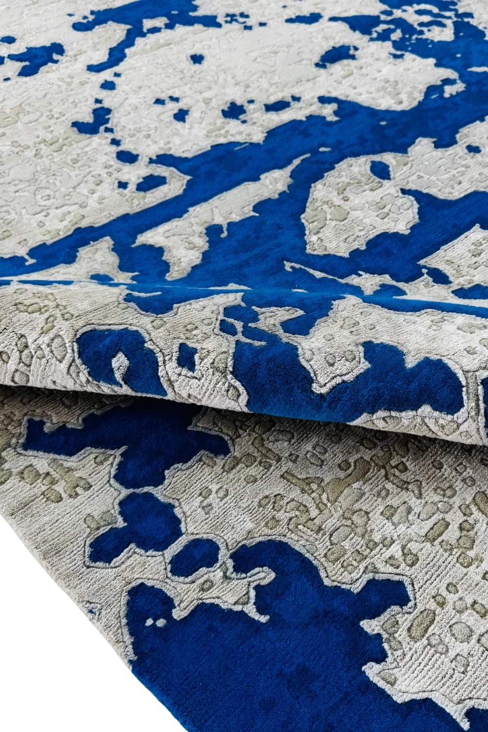 Artistic abstract wool rug with cobalt blue and beige pixel design.