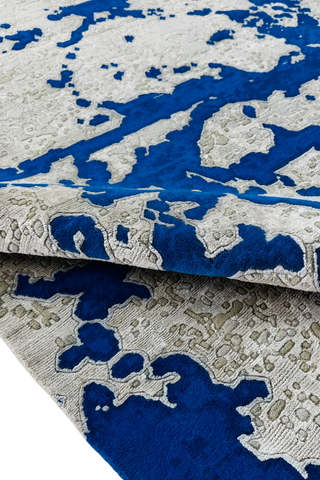 Artistic abstract wool rug with cobalt blue and beige pixel design.