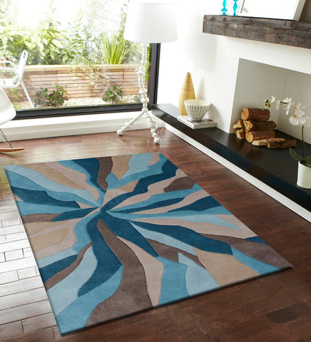 Modern geometric swirl design rug in teal, aqua, and beige.