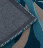 Handwoven luxury rug with blue, beige, and teal swirl abstract design and fabric backing