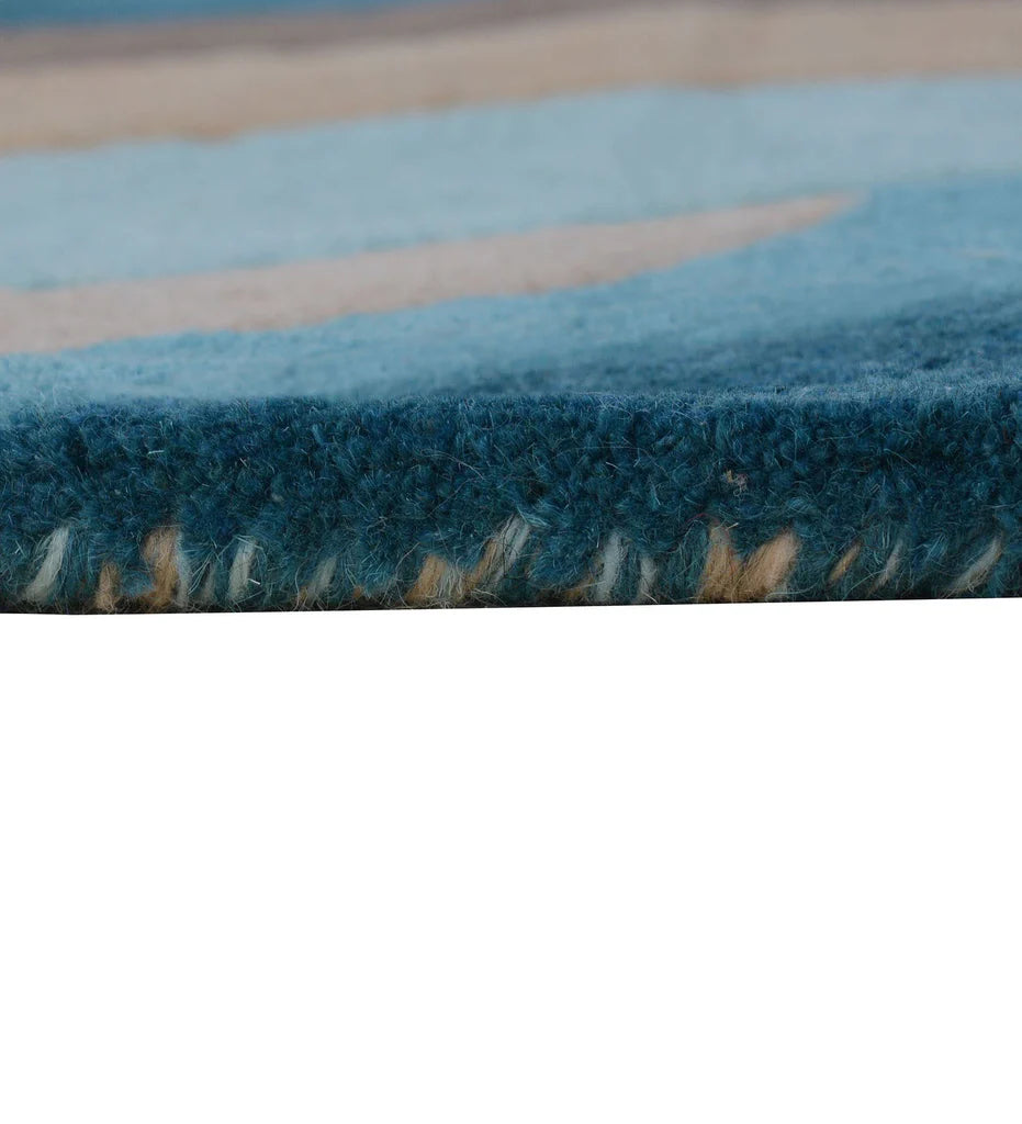 Artistic modern area rug in blue, beige, and chocolate brown.