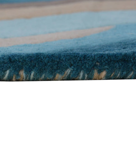 Artistic modern area rug in blue, beige, and chocolate brown.