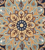 Close-up of blue and beige traditional floral rug with intricate symmetrical pattern