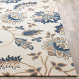 Hand-tufted luxury floral rug with beige, blue, and brown tones on light wood floor