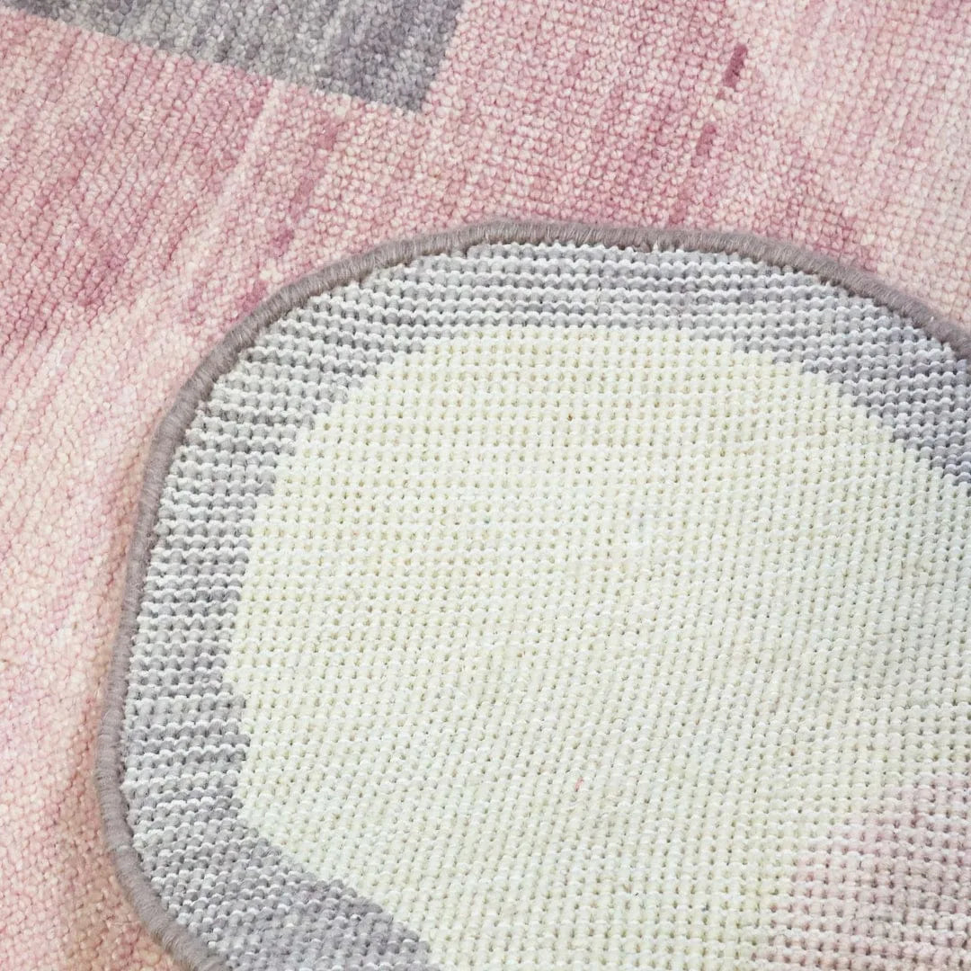 Pink scalloped border hand knotted rug