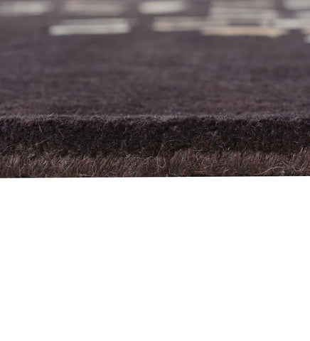 Brown modern wool rug featuring cascading cream and beige motifs