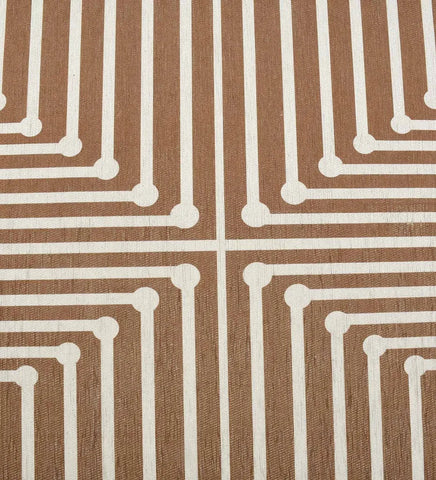 Low-profile brown rug with beige and cream patterns.