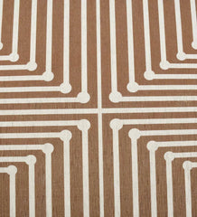 Low-profile brown rug with beige and cream patterns.