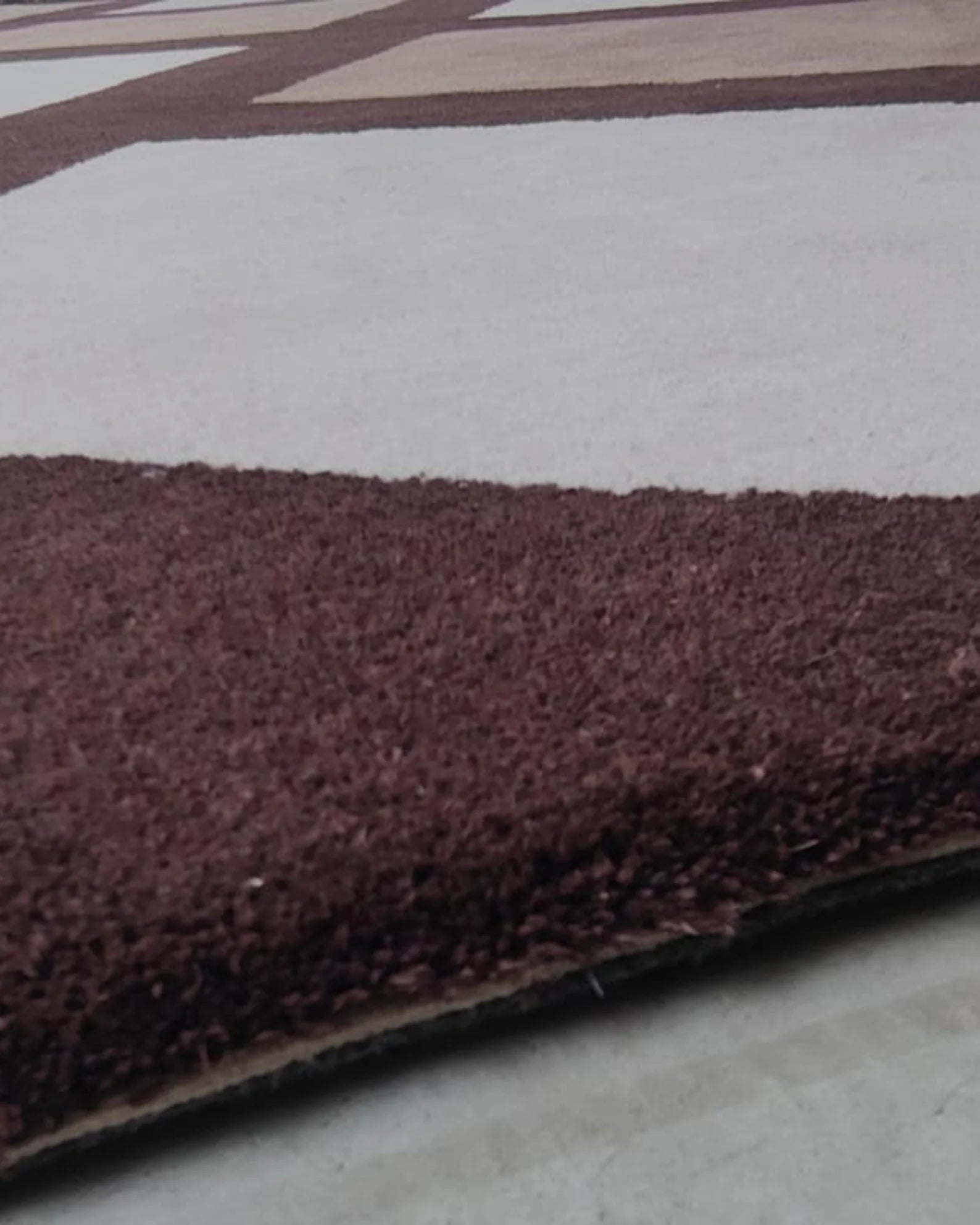 Soft wool rug with contemporary grid pattern and plush pile texture.