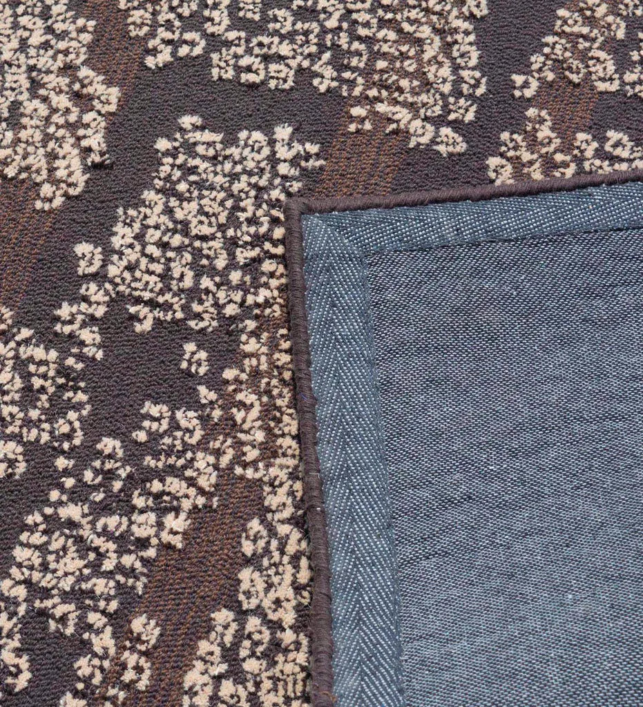 Hand-tufted contemporary rug with textured beige on brown base