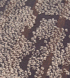 Close-up of brown and beige modern abstract textured rug with clustered pattern