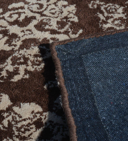 Brown wool rug with ivory damask motifs in distressed design