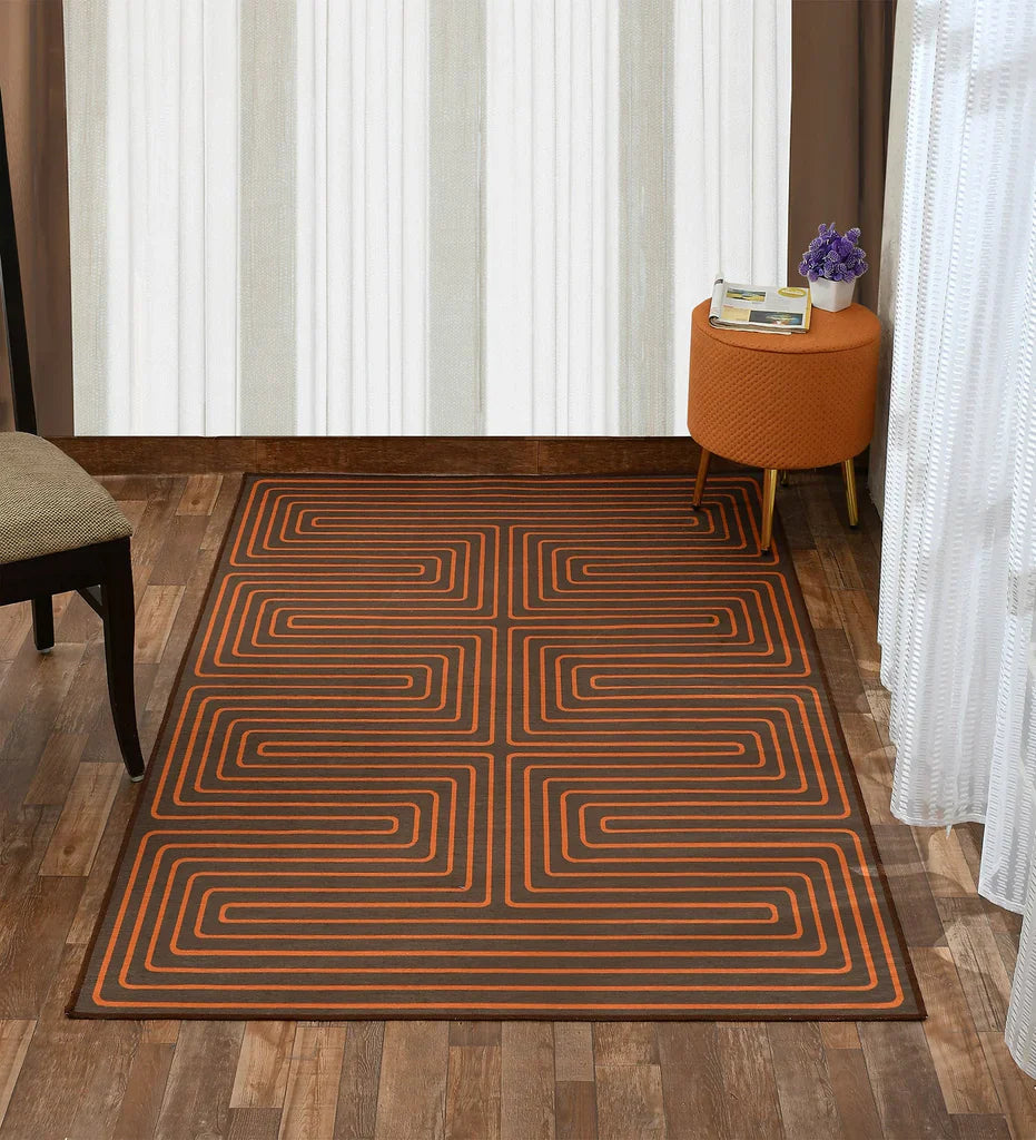 Machine washable burnt orange rug with intricate design.