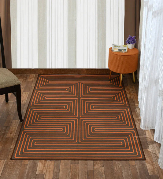 Machine washable burnt orange rug with intricate design.