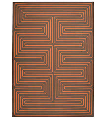 Burnt orange maze patterned rug for modern interiors.