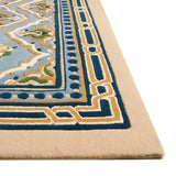 Close-up of Celestia hand-tufted luxury rug with blue, beige, green geometric and floral patterns and decorative border